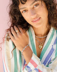 It Girl Heart Necklace on model with striped shirt