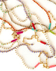 Colorful beaded necklaces and bracelets on a white background