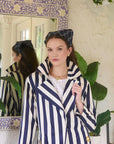 model wearing a headband with a stripe top on a colorful background