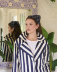 model wearing a headband with a stripe top on a colorful background