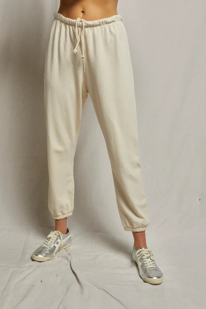 Beige sweatpants worn by a person on a plain background