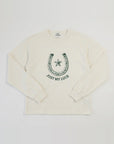 An off-white long-sleeve crewneck sweatshirt featuring a dark green graphic of a horseshoe with a star and the text 'JUST MY LUCK' printed on the chest.