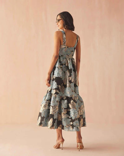 Woman wearing a floral dress against a pink background