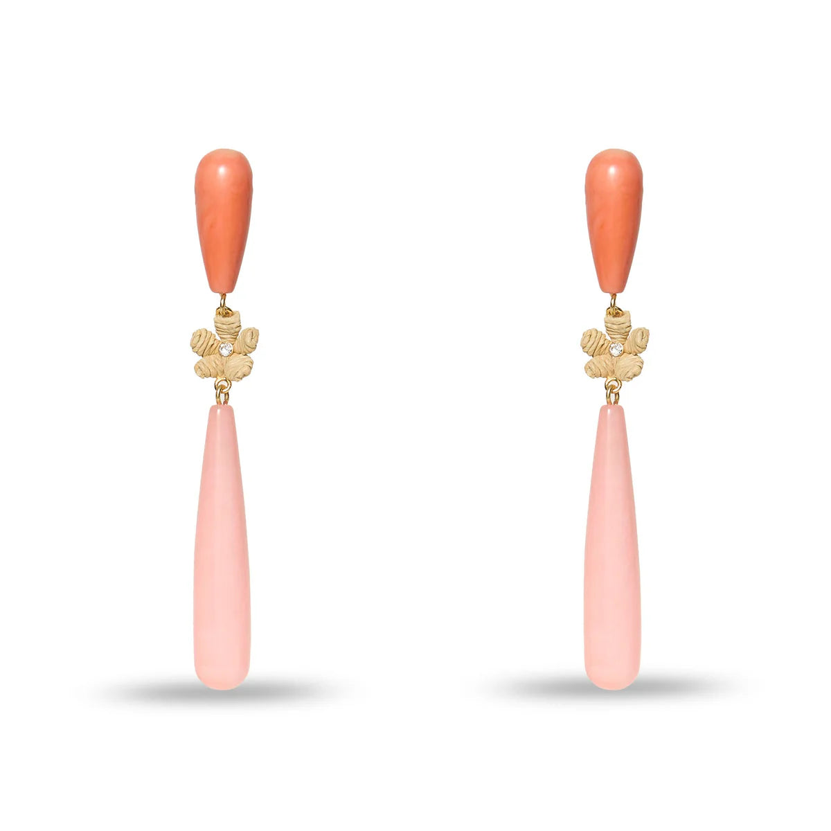 Pair of earrings with coral-colored teardrop pendants on a white background