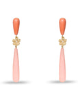 Pair of earrings with coral-colored teardrop pendants on a white background