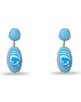 blue and white earrings on white background 