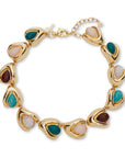Gold bracelet with multicolored stones on a white background