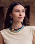 model wearing strand necklace with a cream top 