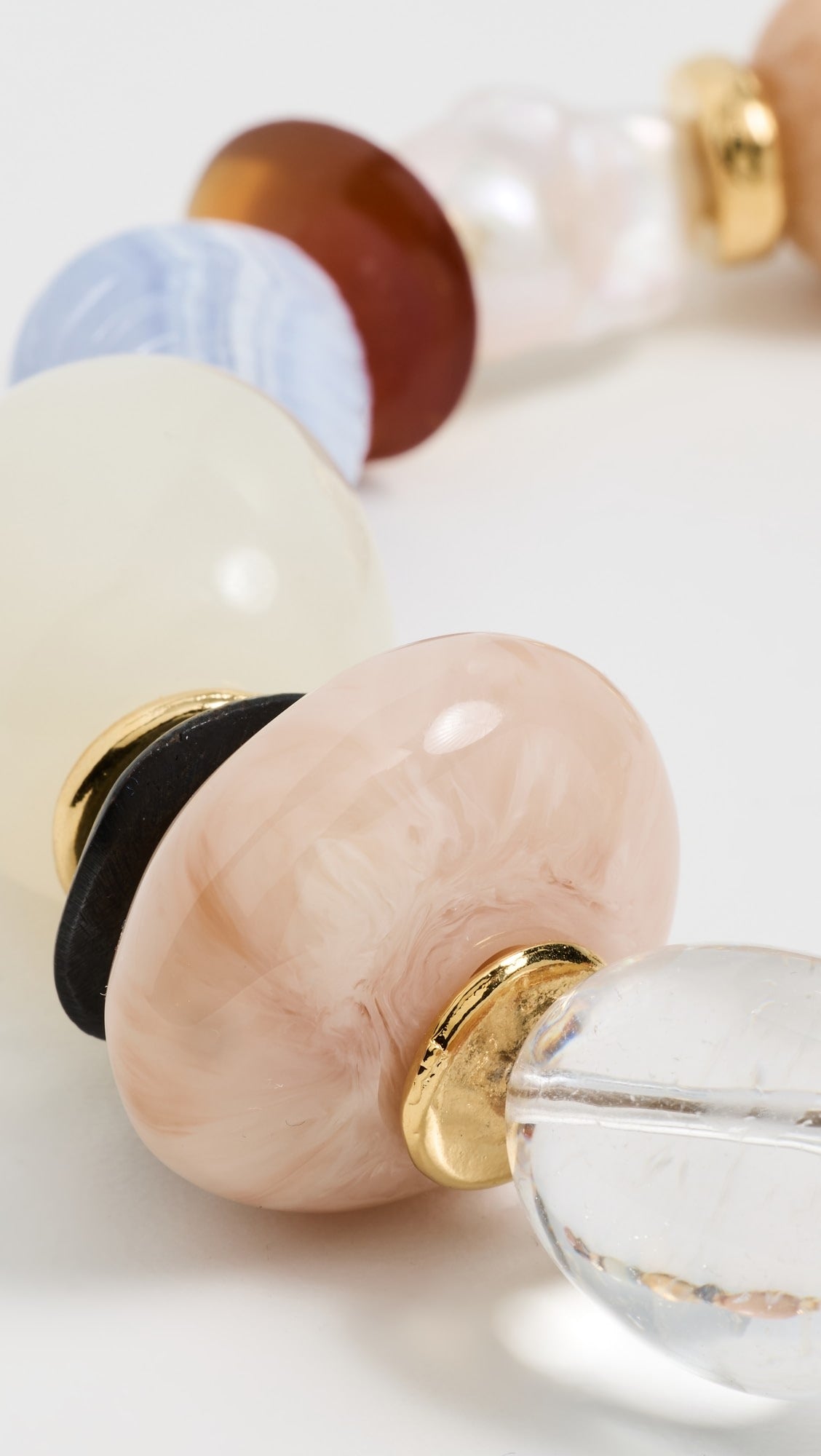 Close-up of a glass bead necklace on light background