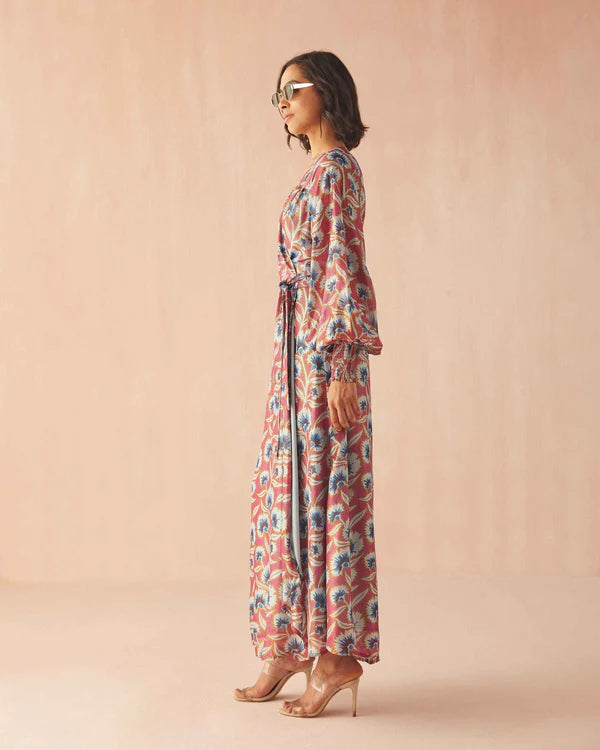 Woman wearing a floral dress against a pink background