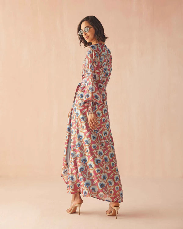 Woman wearing a floral dress against a beige background