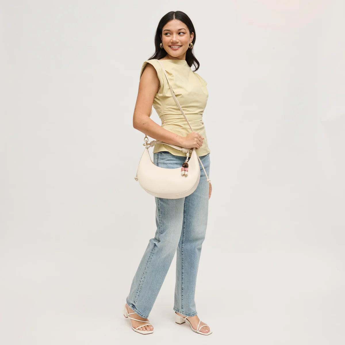 Emilia Hobo Bag on model's shoulder with crossbody strap