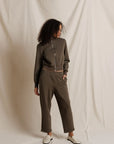 Woman wearing a green tracksuit against a plain background