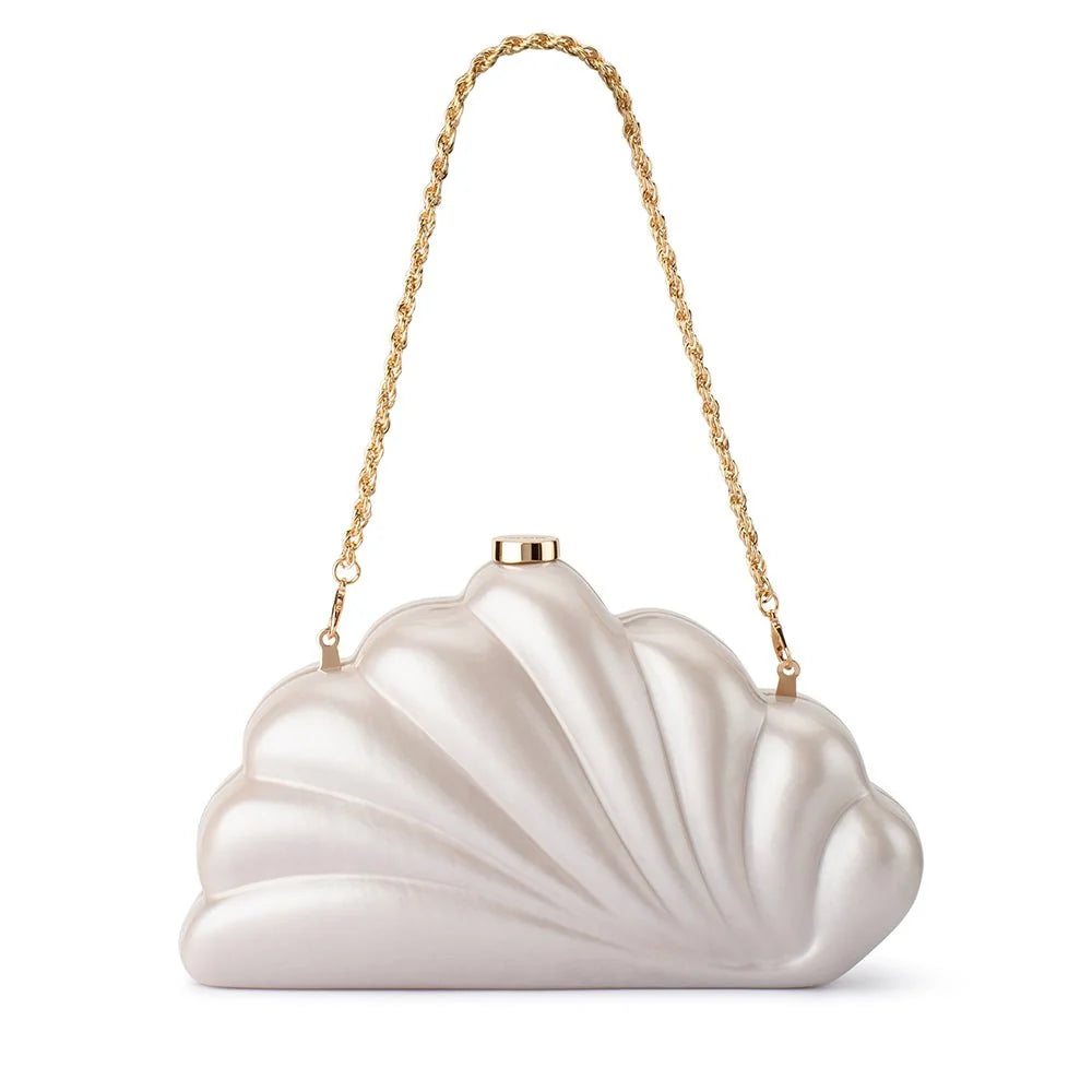 A shell-shaped evening clutch bag in a pearlescent champagne white satin, featuring a gold-tone chain shoulder strap and a gold clasp at the top, set against a plain white background.