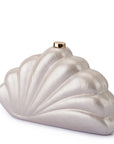 A shell-shaped evening clutch bag with a pearlescent silver finish and a small gold clasp at the top, shown on a plain white background.