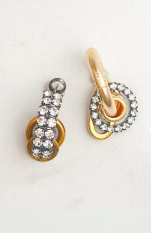 Gold and silver earring on a white background