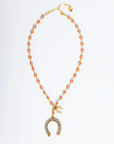 Necklace with a gold and rose gold pendant on a white background
