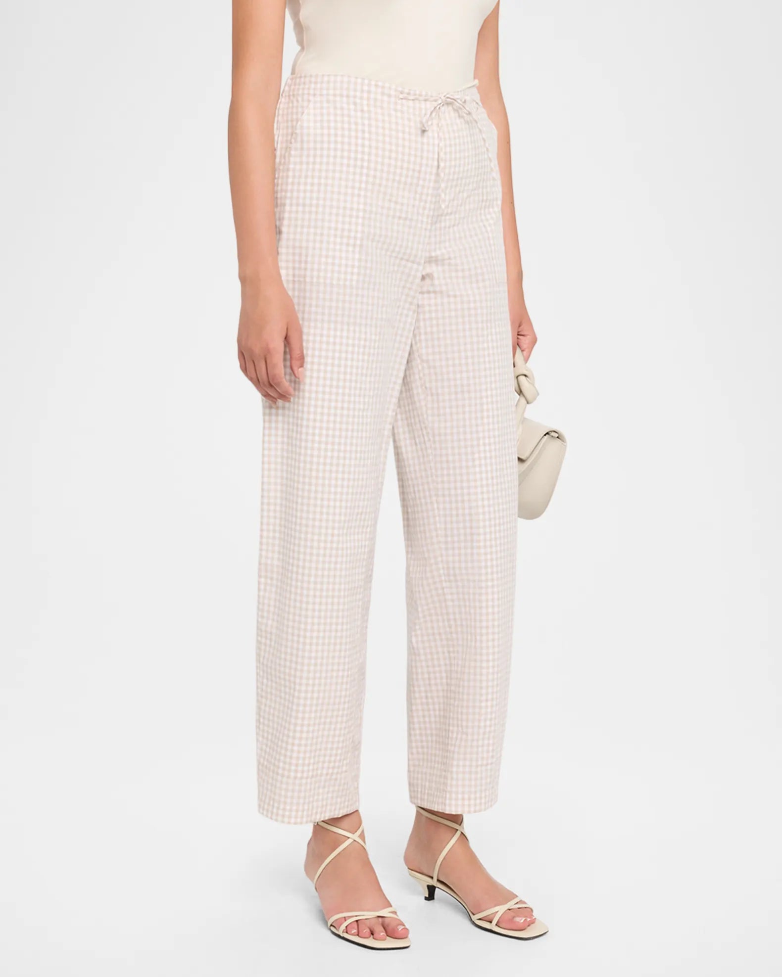 gingham print pants on a model with a white background