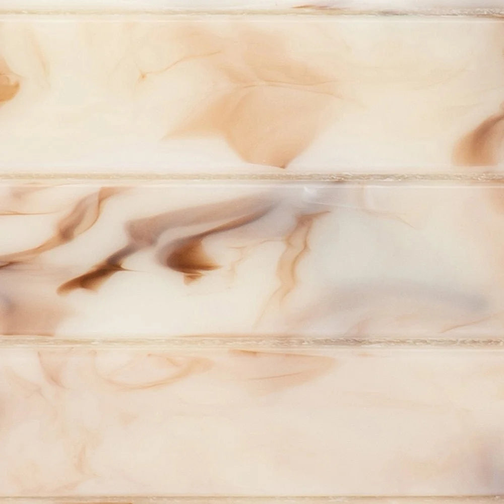 A close-up of a glossy marble-look surface with soft cream, beige, and warm brown veining and horizontal seam lines.