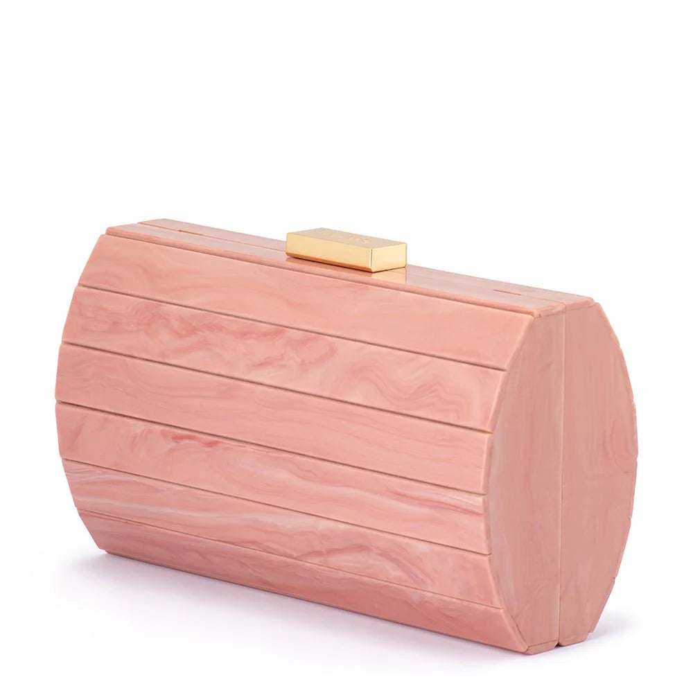 A blush pink wood-grain clutch bag with a small gold metal clasp on top, photographed on a clean white background.
