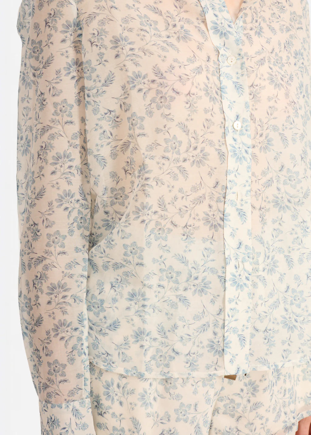 Floral patterned shirt with light blue flowers on a beige background