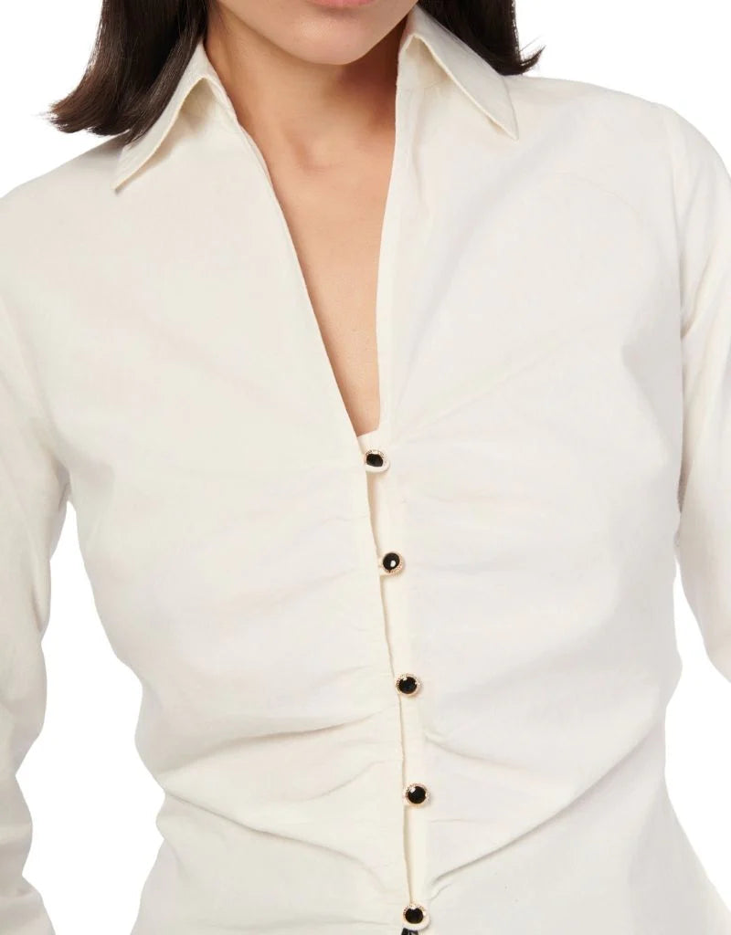 Close-up of a white blouse with buttons on a white background front view