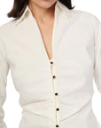 Close-up of a white blouse with buttons on a white background front view