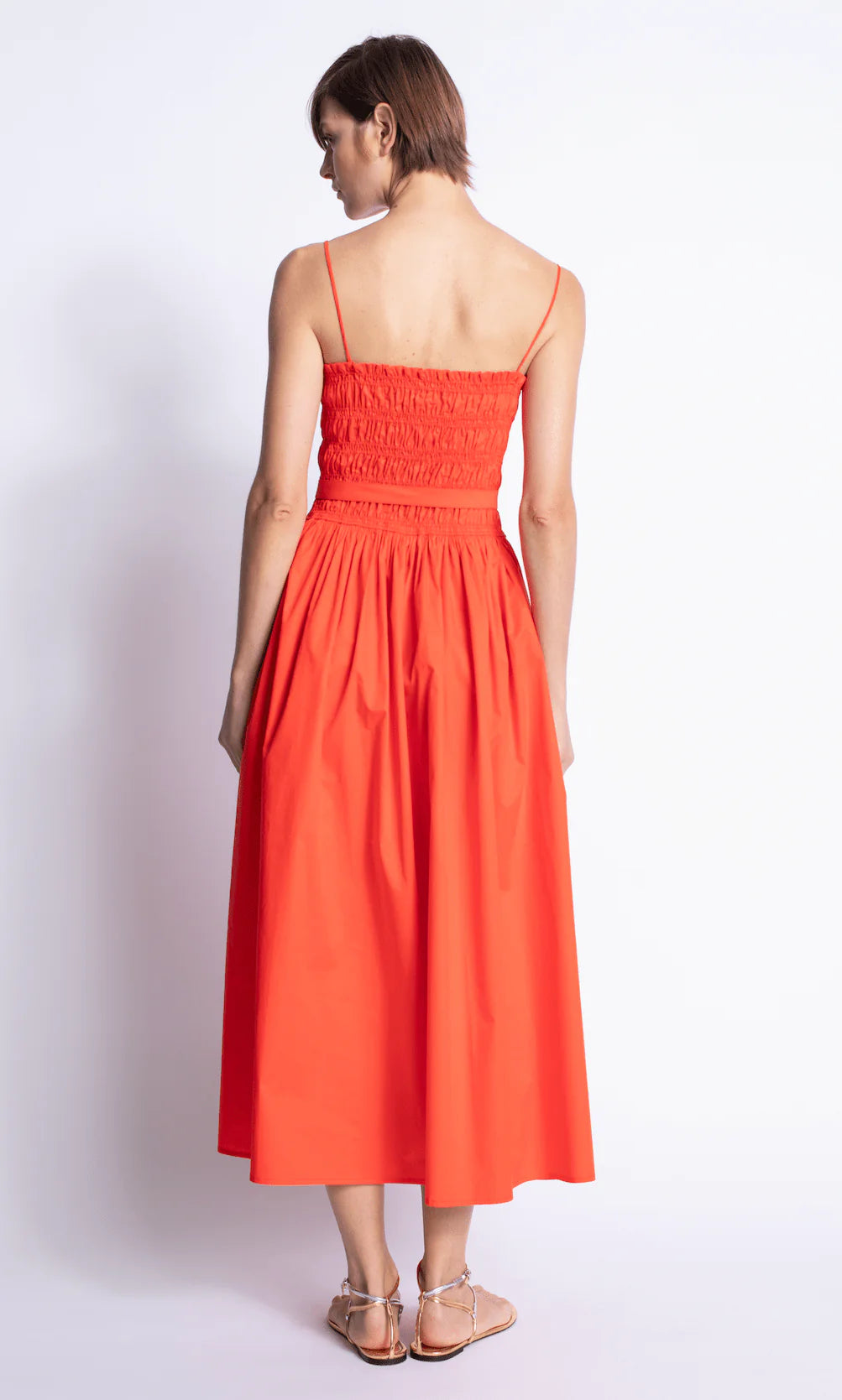 Woman wearing a red dress against a white background