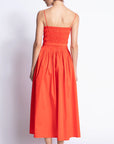 Woman wearing a red dress against a white background