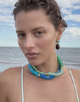 model wearing beaded necklaces on the beach