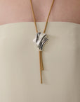 video of woman wearing a bolo tie necklace