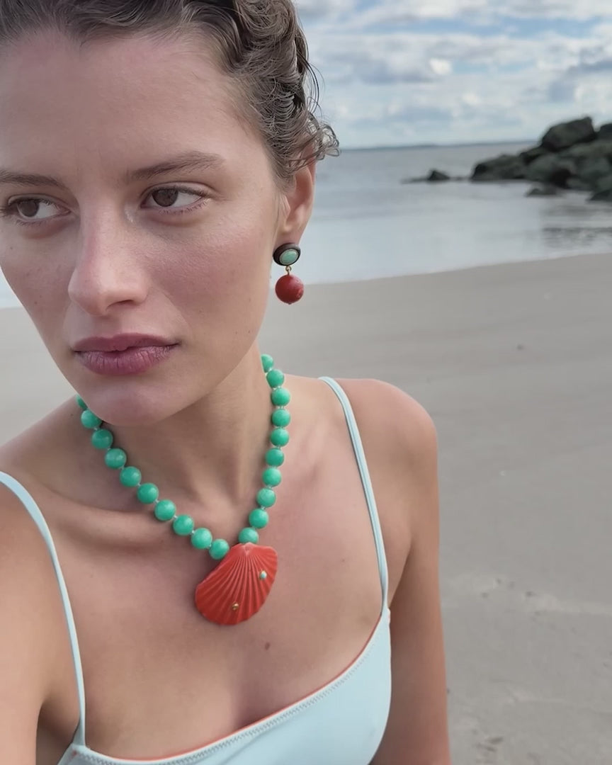 shell necklace on a model at the beach