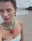 shell necklace on a model at the beach
