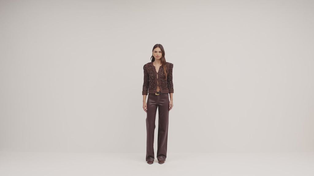 video of a model wearing a brown sparkly sweater and brown leather pants