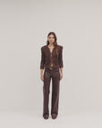 video of a model wearing a brown sparkly sweater and brown leather pants