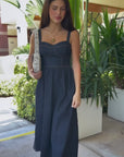 Woman in denim dress with beaded shoulder bag