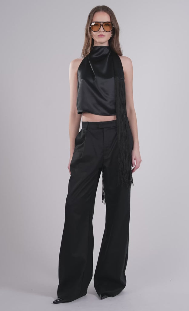 Woman modeling the Freya Top and matching black trousers