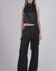 Woman modeling the Freya Top and matching black trousers