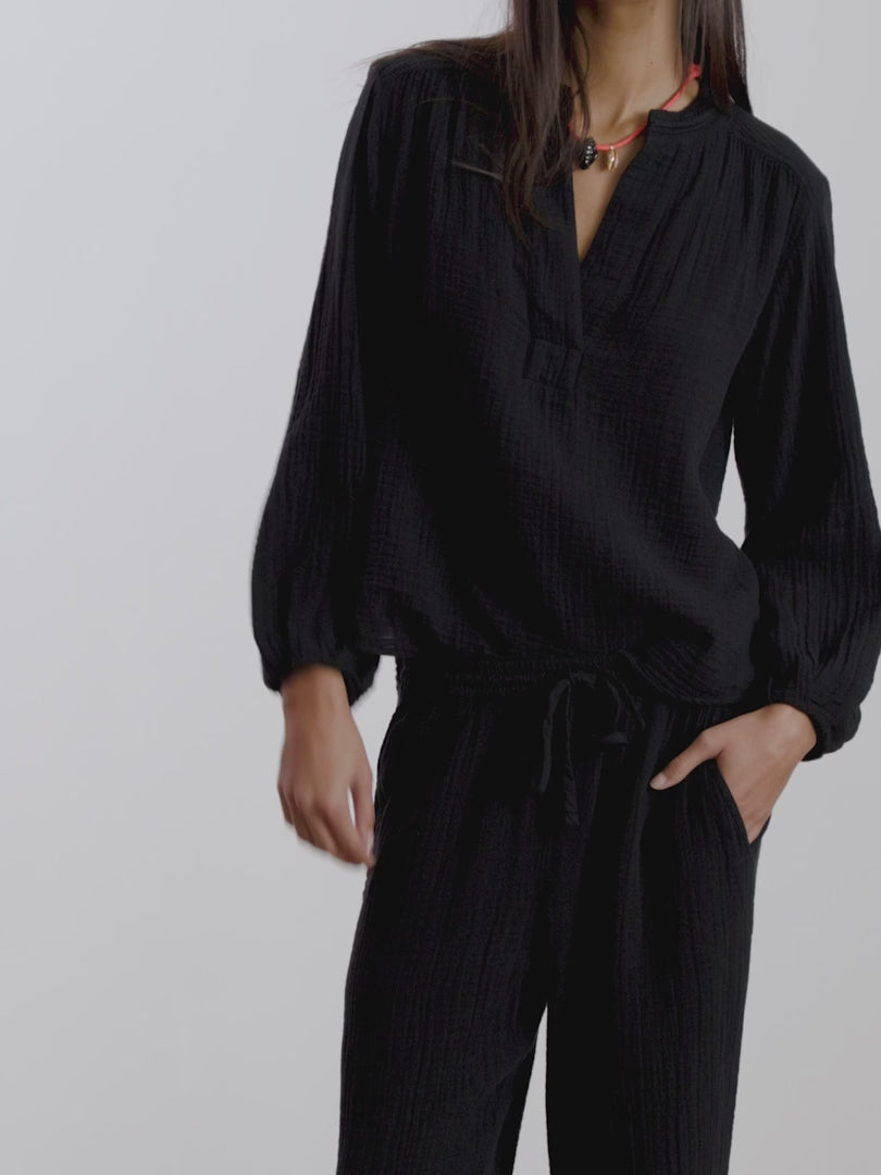 video of woman in a black matching outfit on a white background