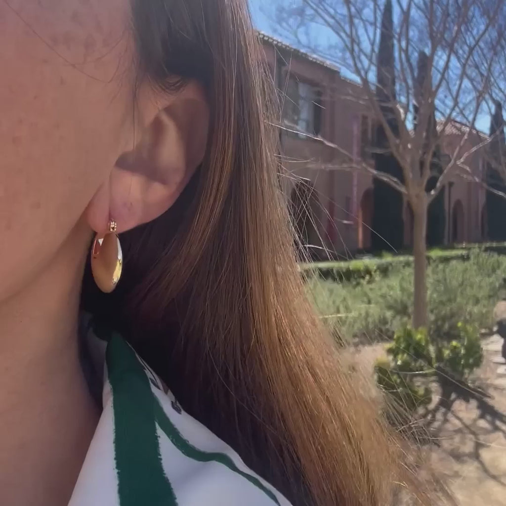 video of a woman wearing gold earrings