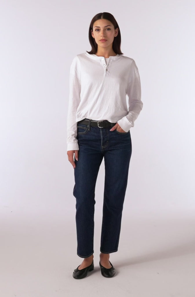 video of model wearing cropped jeans, flats and white long sleeve henley