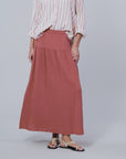 video of a model wearing a striped button up shirt and rust colored skirt