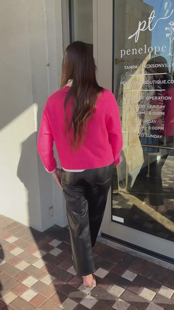 Woman wearing Zeta Ola Sweater with a rhinestone button up, Krewe sunglasses and Ren pants