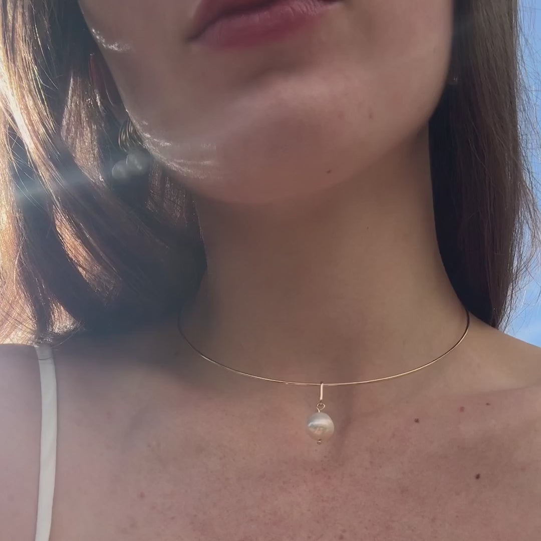 video of a woman wearing pearl jewelry