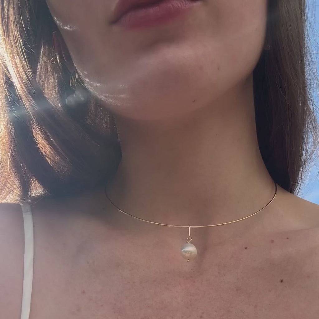 video of a woman wearing pearl jewelry