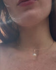 video of a woman wearing pearl jewelry