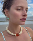 model wearing a beaded necklace on the beach