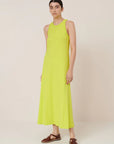 Woman wearing a bright yellow dress against a plain background