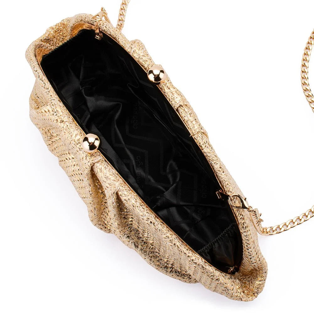 A gold textured clutch handbag with a black satin lining, gold-tone metal accents, and a gold chain strap, shown from an overhead angle on a white background.