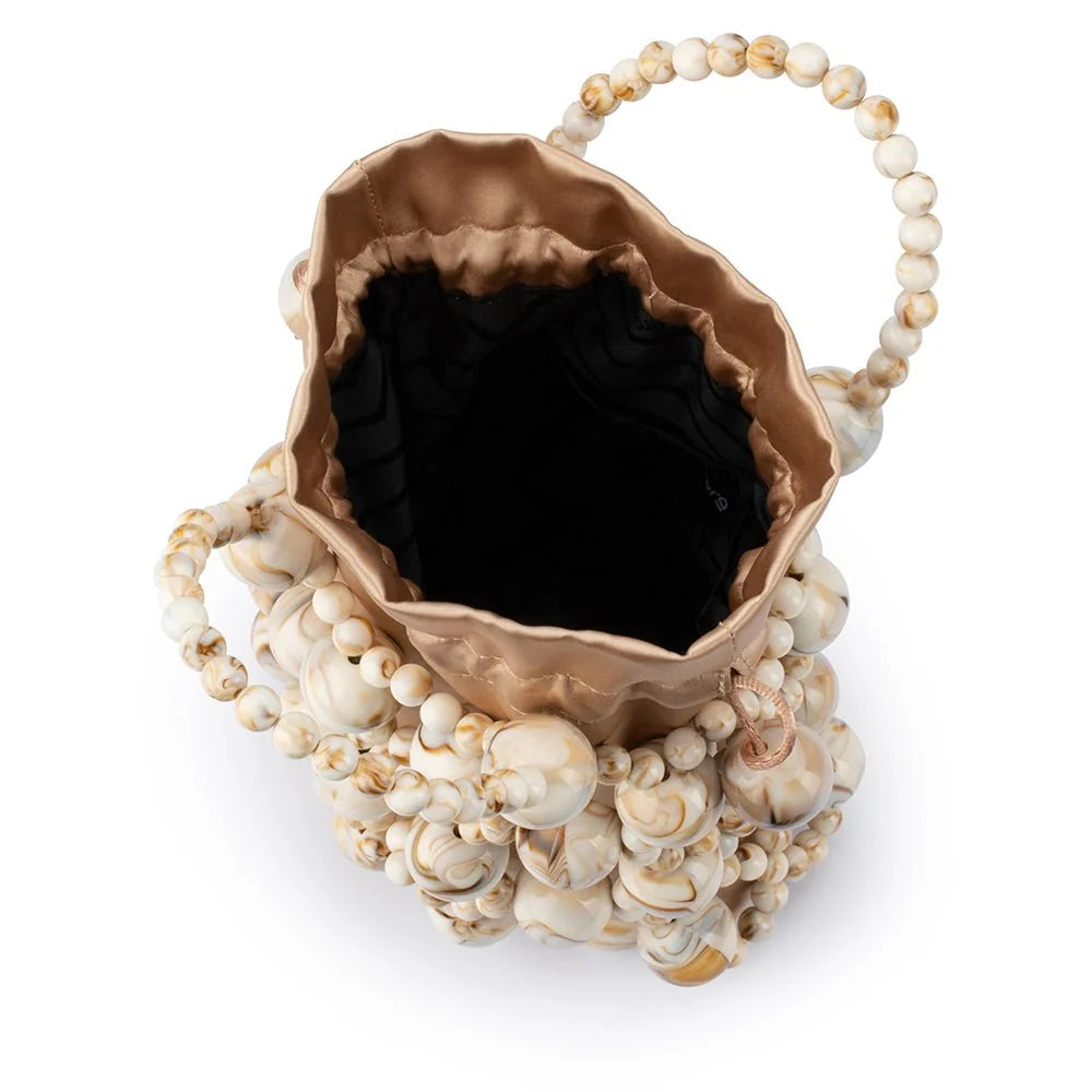 Decorative vase with shell-like design and dark interior on a white background